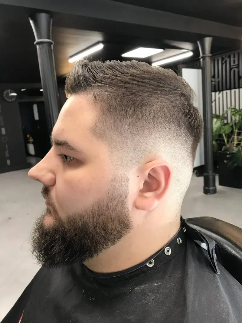 Krótkie męskie strzyżenie z skin fade oraz pełną, równo wykończoną brodą